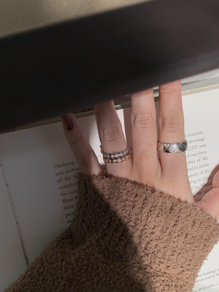 Collection of delicate gold necklaces with circle and pendant designs on black background — quiet luxury jewelry that transitions from office to evening, elegant and affordable under $200.