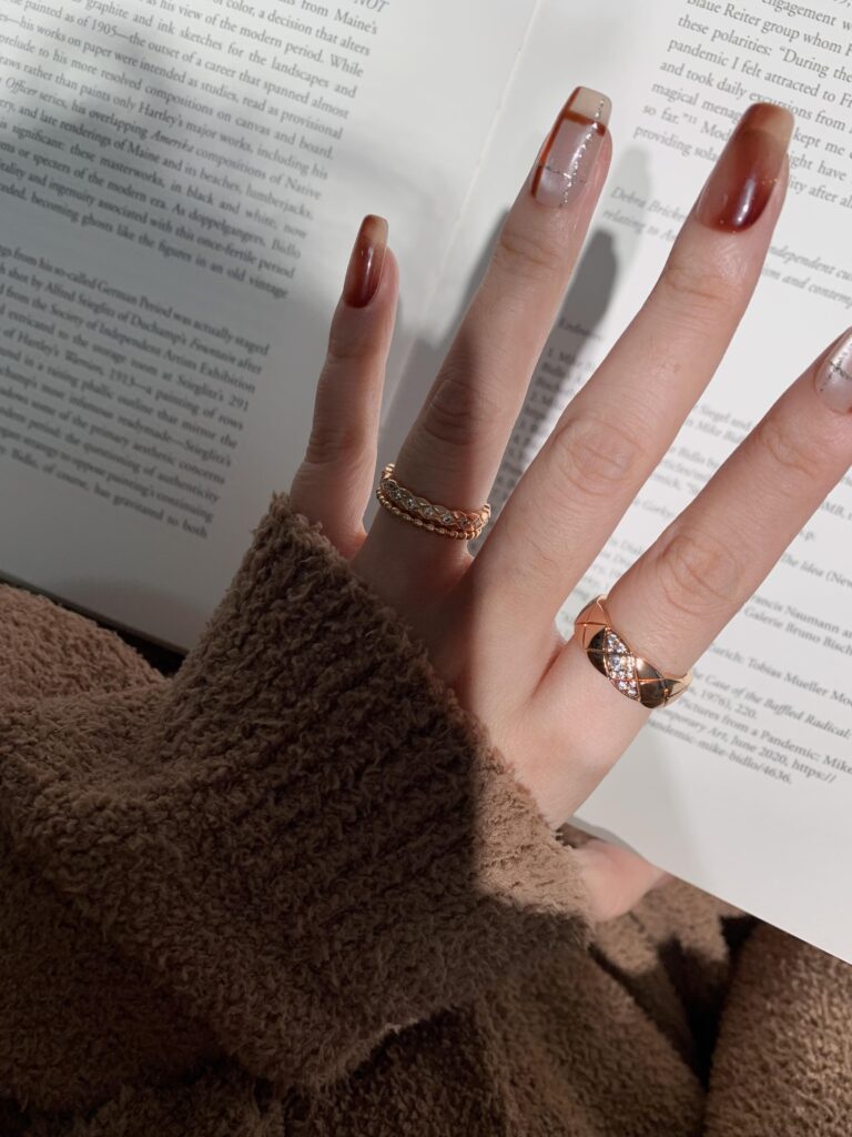 Macro close-up of gold pendant necklaces featuring quilted and C-shaped designs with crystal accents — quiet luxury jewelry crafted for effortless elegance, perfect for modern minimalist style under $200.