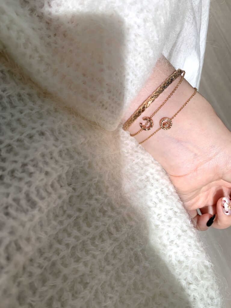 Gold and silver bangle bracelets with quilted patterns and crystal details, styled with a chic black outfit — affordable quiet luxury jewelry for women, elegant and timeless accessory that elevates everyday looks.